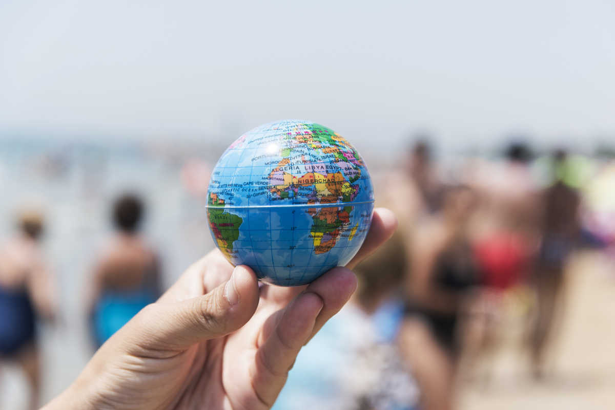 young man with a world globe in his hand