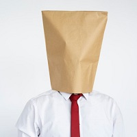 Anonymous man head covered with paper bag